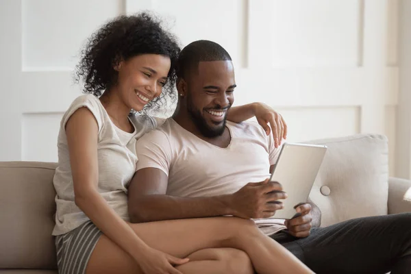 Sonriendo pareja afroamericana usando tableta juntos . — Foto de Stock