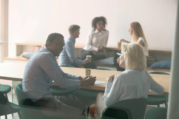 Diverse employee talk discussing ideas at break in boardroom — Stock Photo, Image