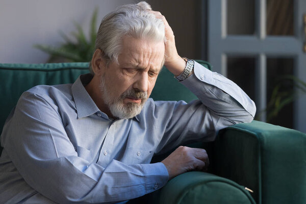 Upset elderly man feel lonely lost in thoughts