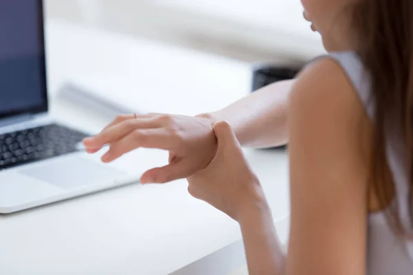 Hurt woman worker massage wrist suffering from spasm — Stock Photo, Image