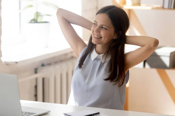 Sonriente joven empleada mirada en la distancia soñando — Foto de Stock