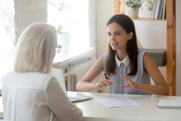 Millennial woman specialist talk consulting senior female — Stock Photo, Image