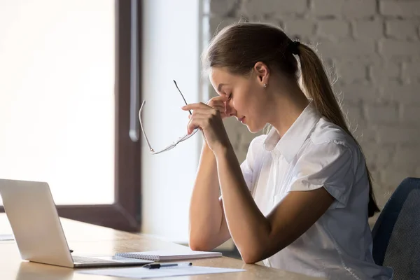 Tired businesswoman taking off glasses, suffering from eye strain — Stock Photo, Image