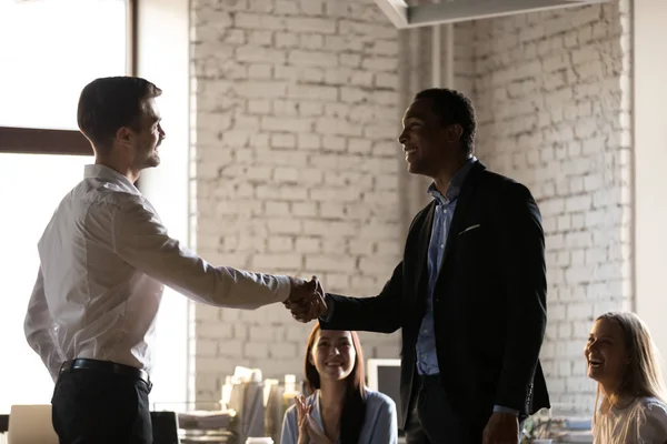 Boss shaking hand of successful African American employee at briefing — Stock Photo, Image