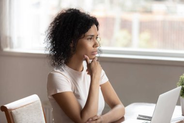 Pensive biracial woman look in distance thinking clipart