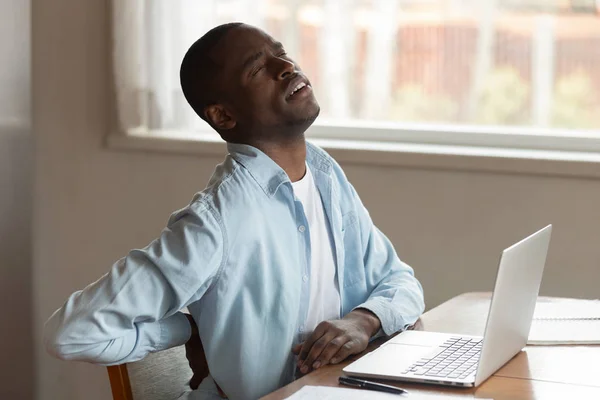 Hurt biracial man suffer from lower back pain — Stock Photo, Image
