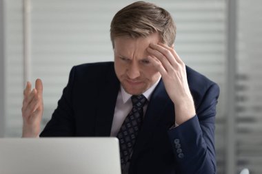 Stressed middle aged male director annoyed by bad news mail.