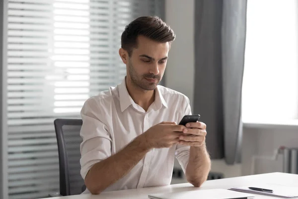 Serious young executive manager using internal company messenger application. — Stock Photo, Image