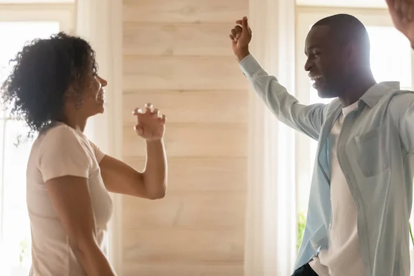 Happy biracial couple have fun dancing at home together — Stock Photo, Image