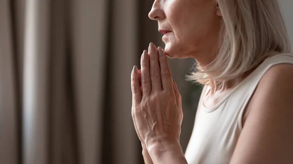 Close up mature woman puts hands in prayer with hope — Stock Photo, Image