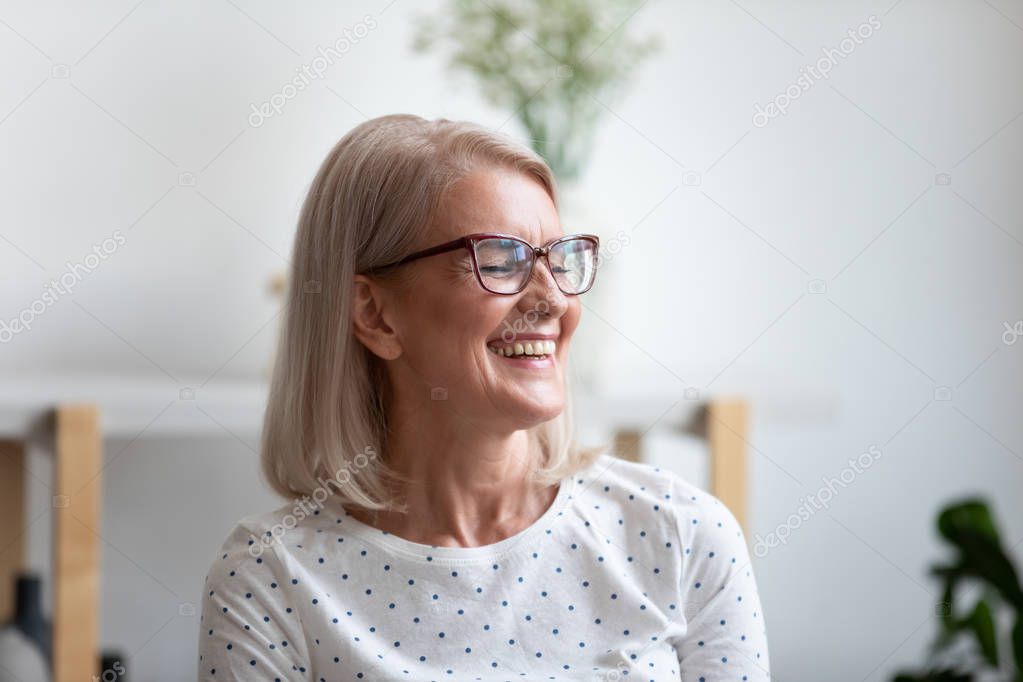 Close up happy beautiful mature woman laughing at funny joke