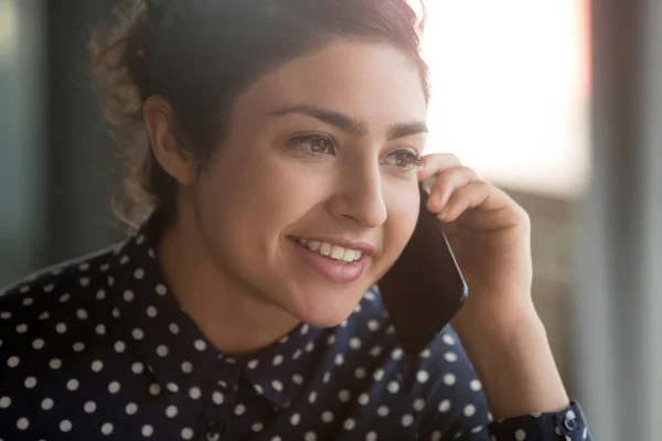 Smiling indian businesswoman secretary manager make business call at work