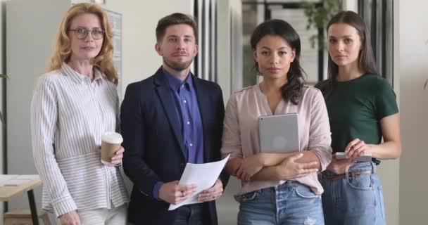 Confident multiracial business people stand in office, team portrait — Stock Video