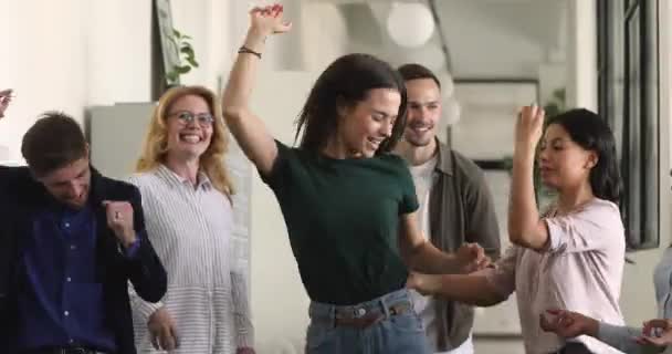 Happy multiracial team with female leader dancing at corporate party — Stock Video