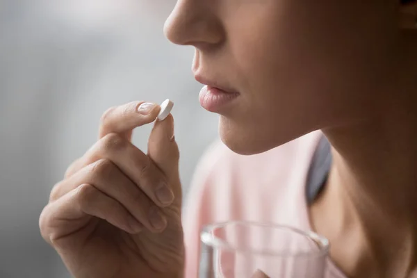 Sick woman holding pill glass of water, close up view — Stock Photo, Image