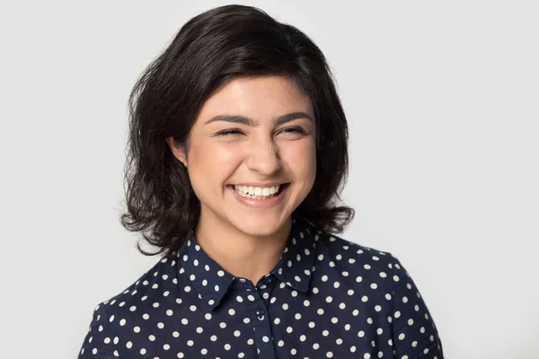 Happy indian girl posing in grey studio background