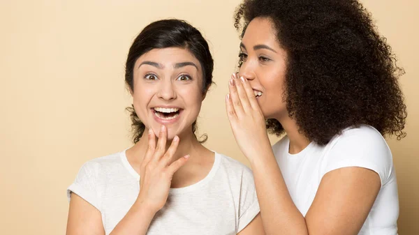 Happy multiethnic millennial girlfriends gossip share secrets — Stock Photo, Image