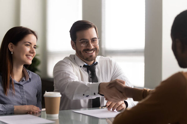 Happy hr manager welcoming african american employee at new job.