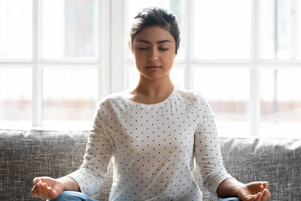 Calm Indian woman with closed eyes meditating at home — Stock Photo, Image