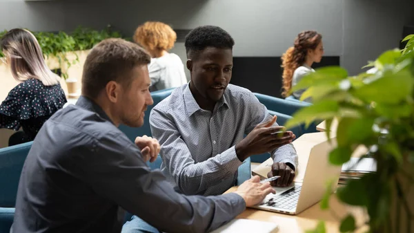 African and european colleagues analyzing new corporate apps — Stock Photo, Image