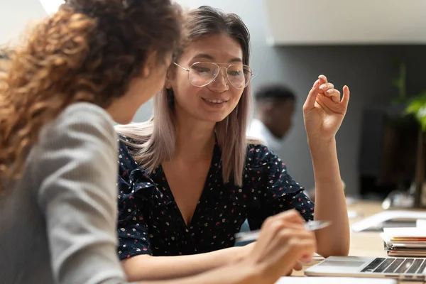 Multiethnic colleagues doing common task using laptop thinking on project — Stock Photo, Image