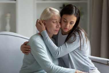 Millennial upset lady calming soothing depressed middle aged mother.