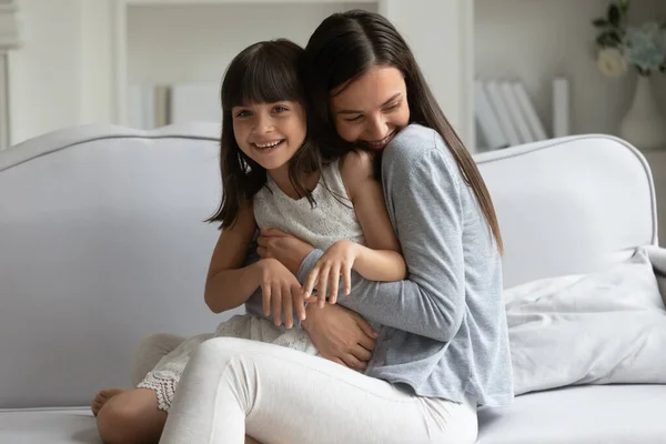 Happy mother holding cuddling cute adopted child at home. — Stock Photo, Image