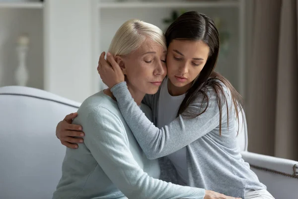 Millennial upset lady calming soothing depressed middle aged mother.