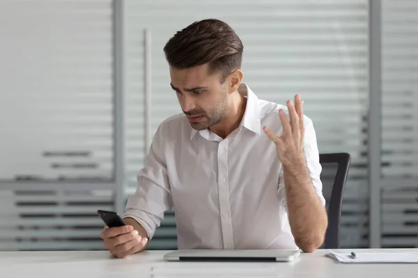 Confused businessman having problem with cellphone, receive bad news — Stock Photo, Image