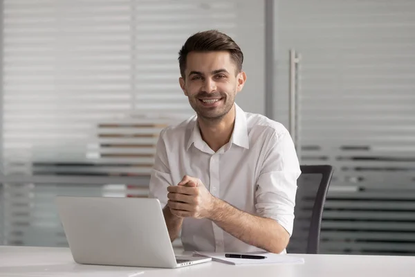 Head shot portrait happy smiling businessman sitting at office desk — Stock Photo, Image