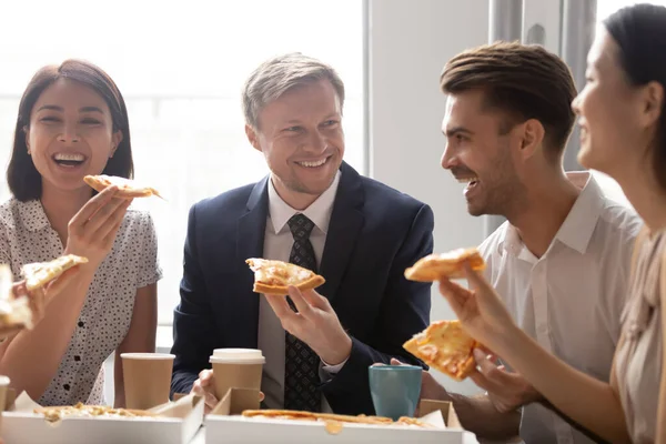 Diversos compañeros de trabajo felices compartiendo comida en el almuerzo — Foto de Stock