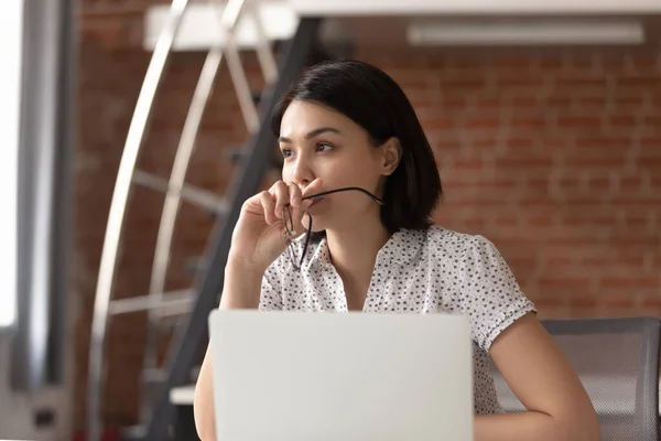 Thoughtful Asian businesswoman taking off glasses, pondering ideas — Stock Photo, Image