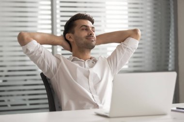 Satisfied businessman in comfortable office chair during break
