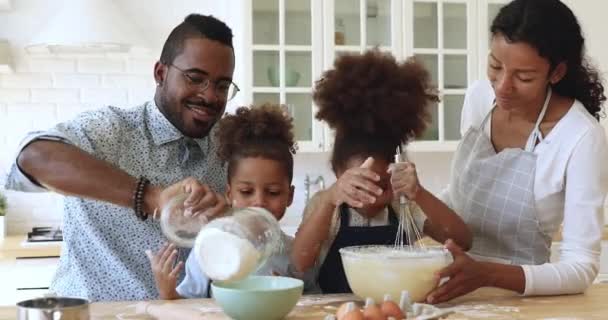 Afro american parents teaching cute kids learning making dough — Stock Video