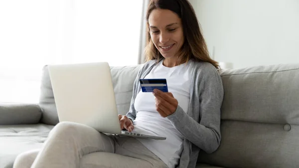 Smiling millennial mixed race woman making purchases online. — Stock Photo, Image