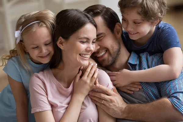 Счастливая семья наслаждается нежным моментом, родители и дети обнимаются — стоковое фото