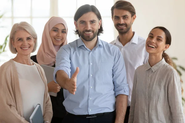 Happy ceo extend hand at camera stand with multicultural businesspeople — Stock Photo, Image