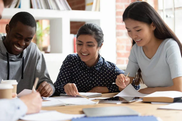 Indian, african, asian classmates do school assignment together indoors — Stock Photo, Image