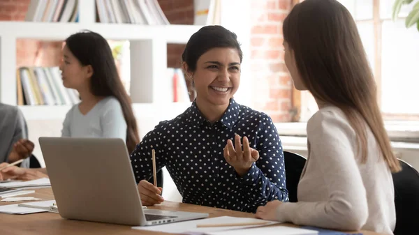 Multiracial students seated inside of modern classroom do shared task — Stock Photo, Image