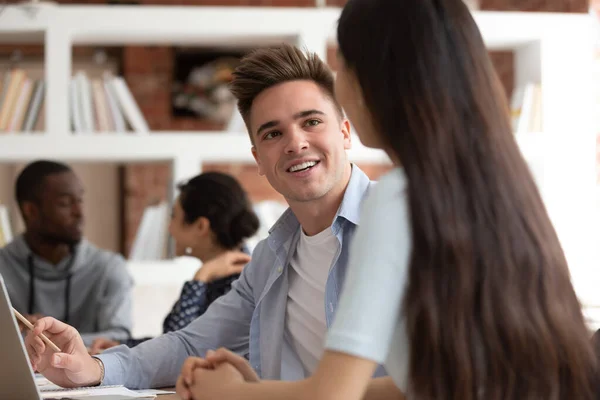 European guy vietnamese girl classmates studying together sitting at desk — Stock Photo, Image