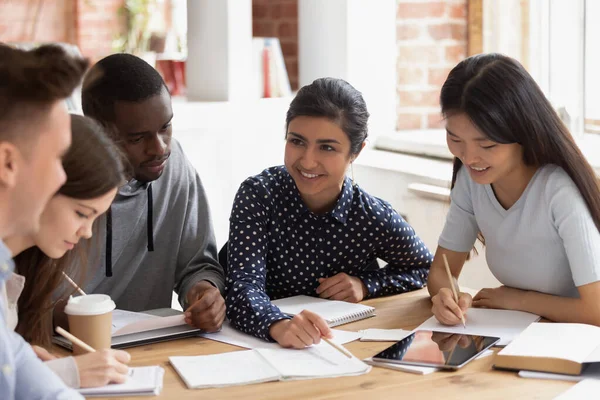 Focused multi national students sitting at desk studying together — Stock Photo, Image