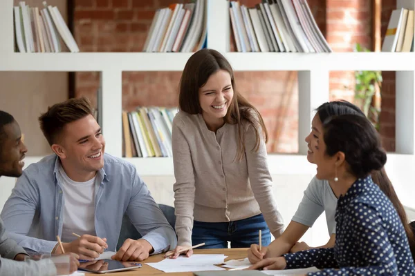 Multiracial students listen caucasian girl team leader do common task — Stock Photo, Image