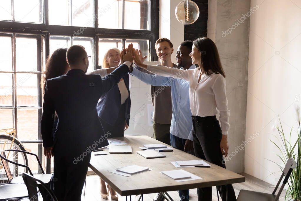 Happy motivated multiracial office people group giving high five