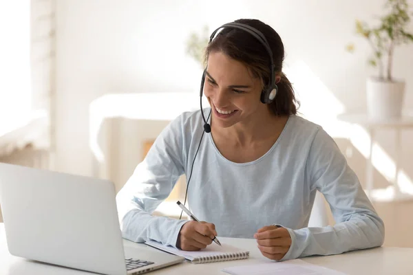 Happy mixed race young woman wearing headset, watching educational lecture. — Stock Photo, Image