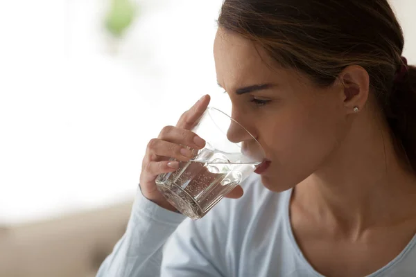 Close up young mixed race woman drinking glass of water. — Stock Photo, Image