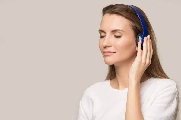 Caucasian young woman listen to music in earphones