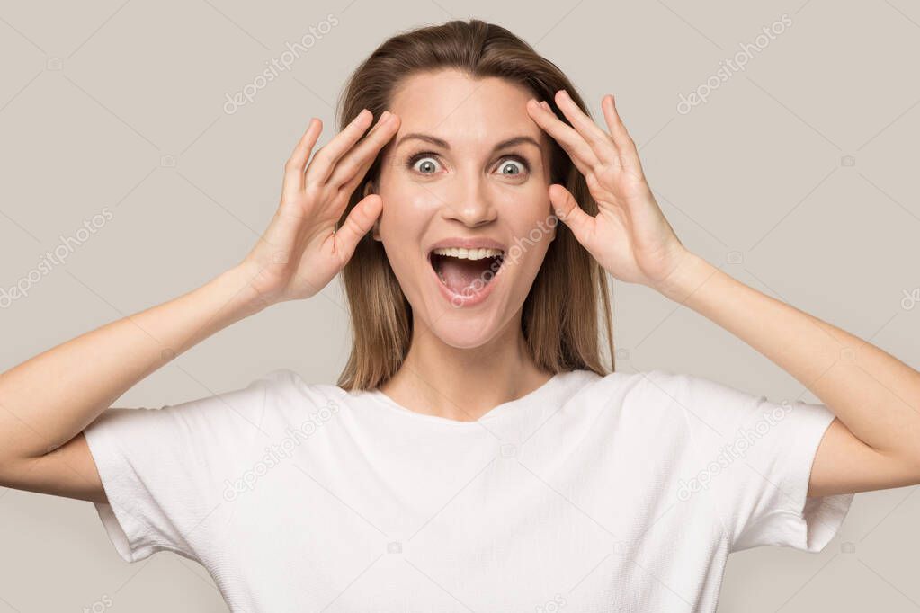 Excited Caucasian woman look at camera shocked by promotion