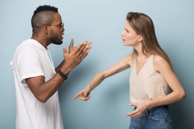Angry multiracial couple engaged in fight having relations problems clipart