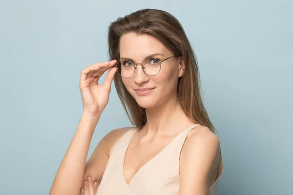 Portrait of millennial woman posing in glasses in studio — Stock Photo, Image