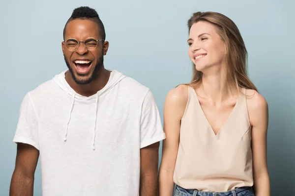 Overjoyed multiethnic couple laugh at funny joke together — Stock Photo, Image